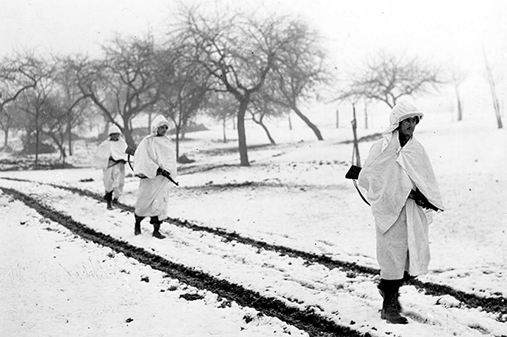 US soldiers marching in Luxembourg, using bedsheets for camouflage. Courtesy of US Army